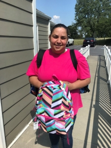 woman holding a school kit bag