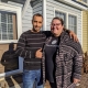 Katie and her husband standing in front of their new home in Harrisonburg